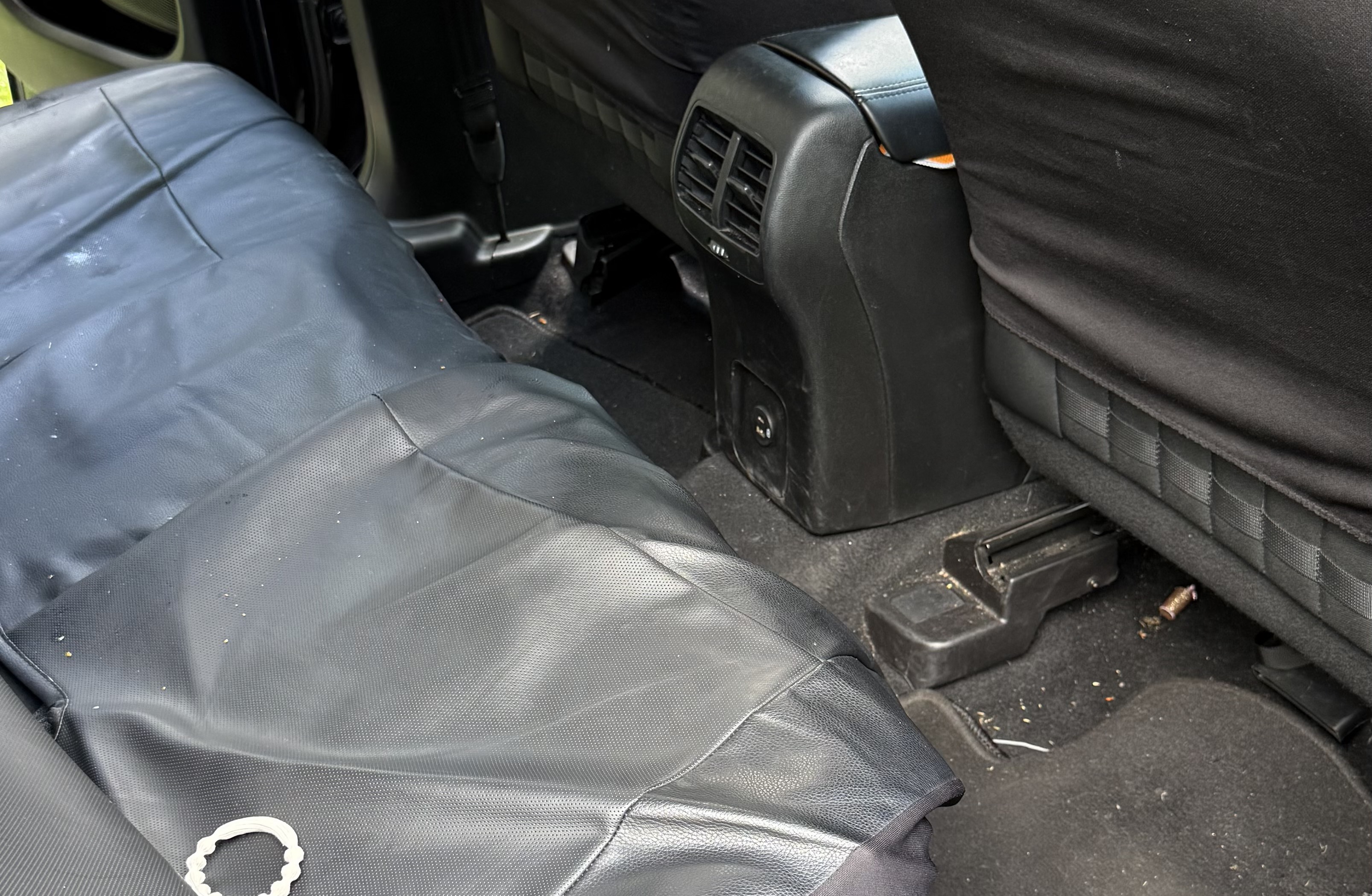 A debris-filled rear seat and floor before detailing in Sharonville