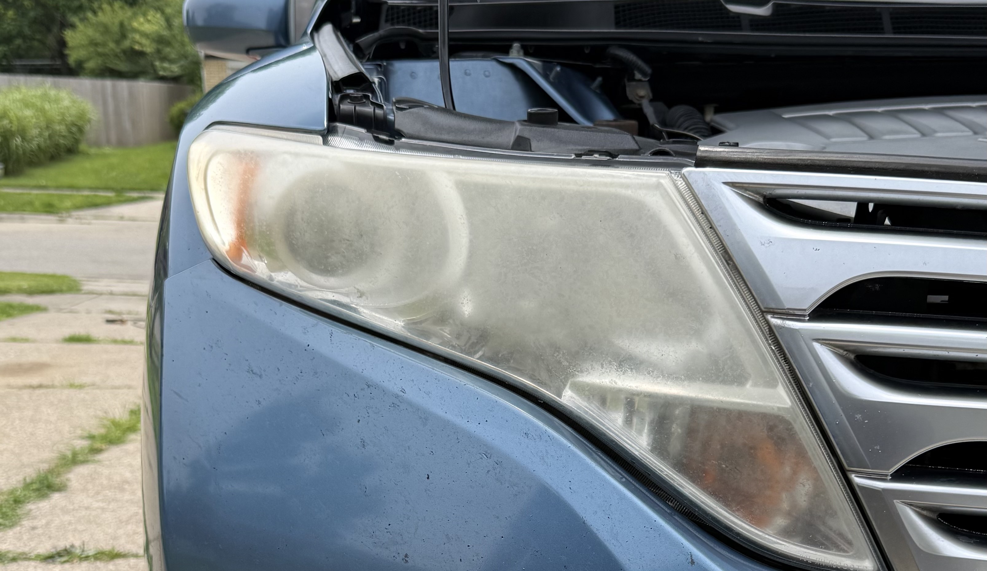A yellowed foggy headlight before detailing in Mariemont