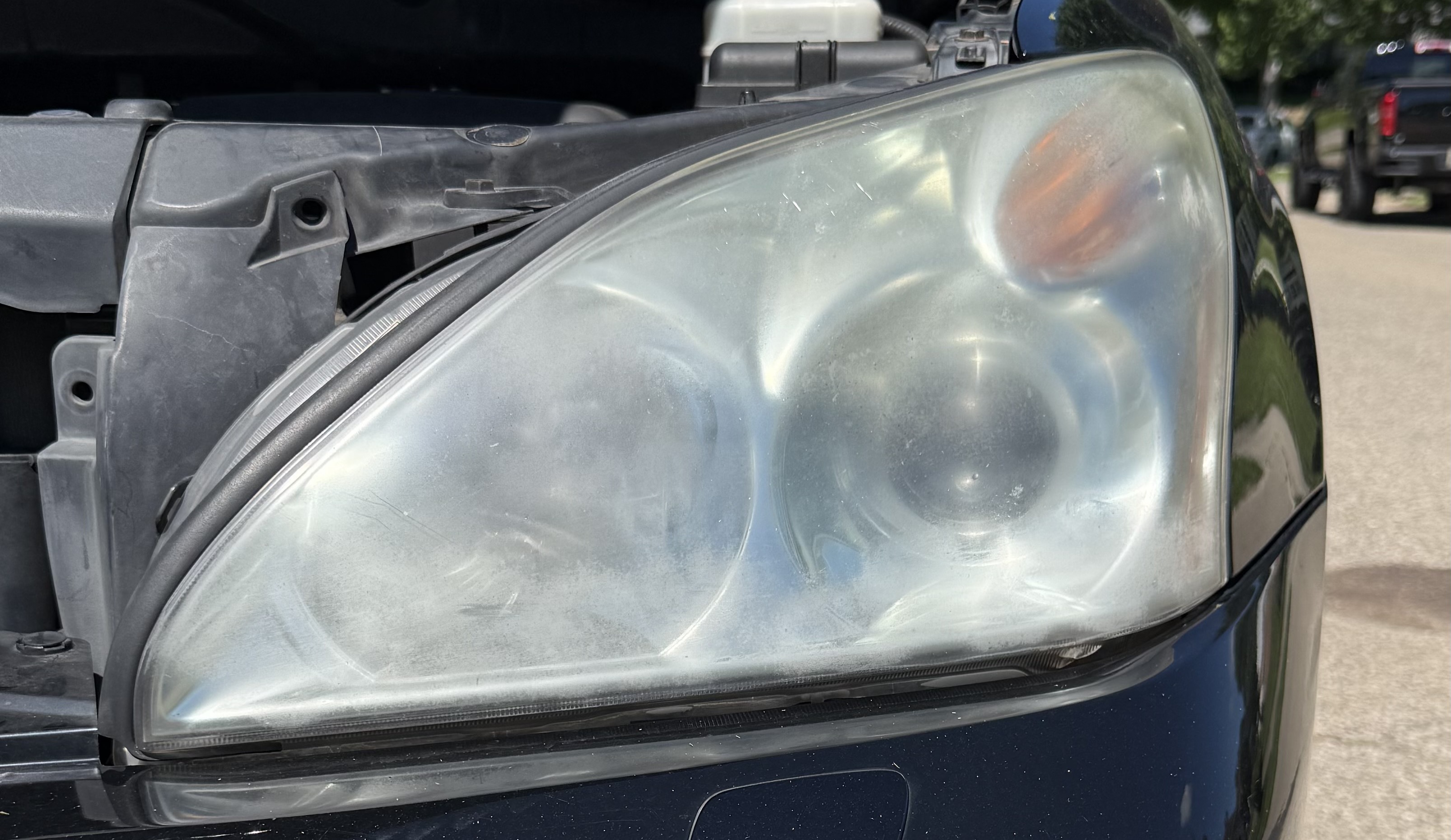A cloudy headlight before detailing in Hyde Park
