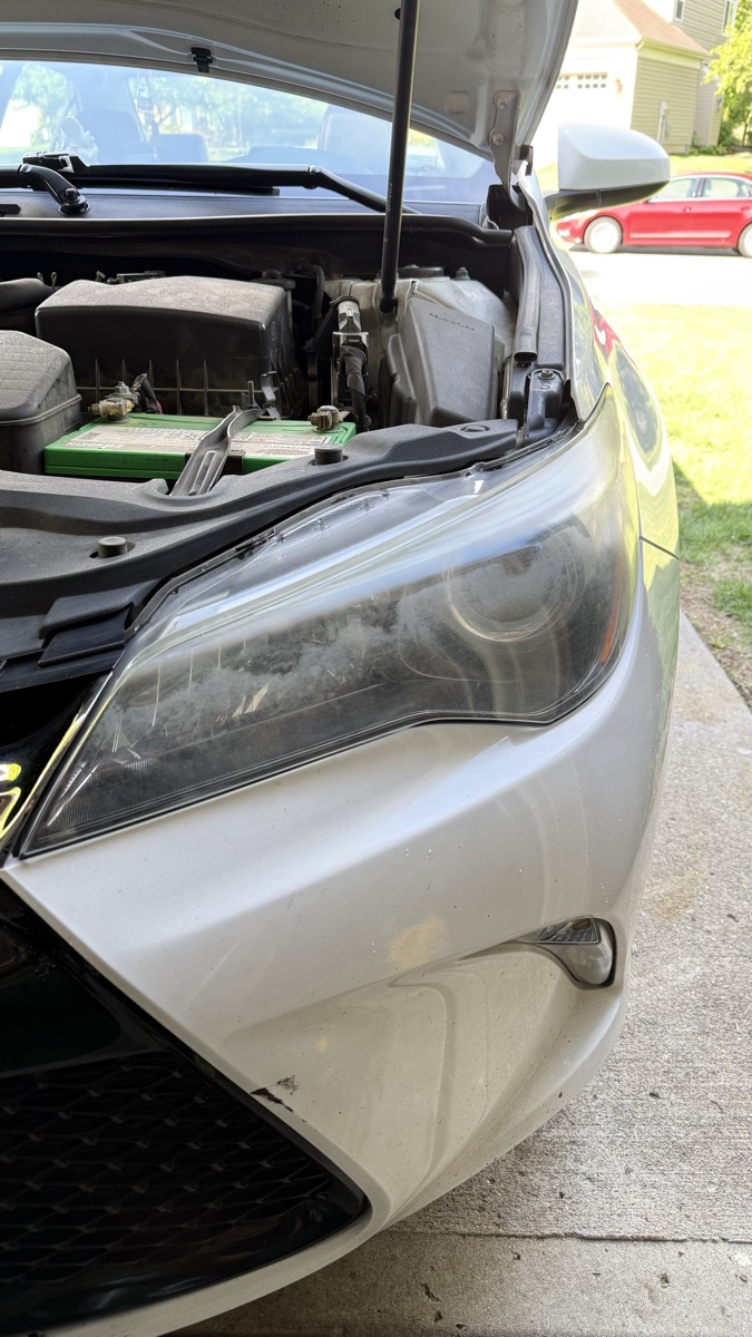 Severely oxidized foggy headlight before restoration — Cincinnati
