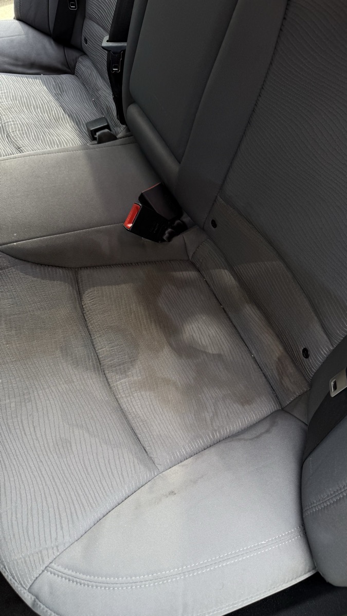 Stained car seats before interior detail Cincinnati