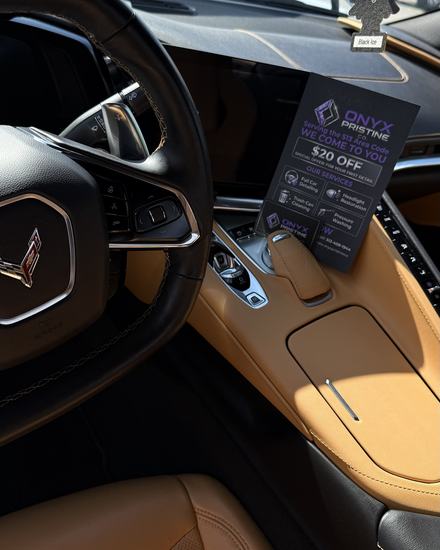 Corvette C8 cockpit after an interior detail: tan leather, console and wheel clean