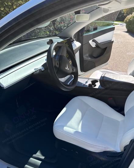 Tesla white leather front seat and dash after an interior detail