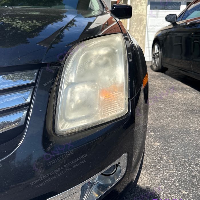 Ford Fusion headlight before restoration: yellowed and foggy